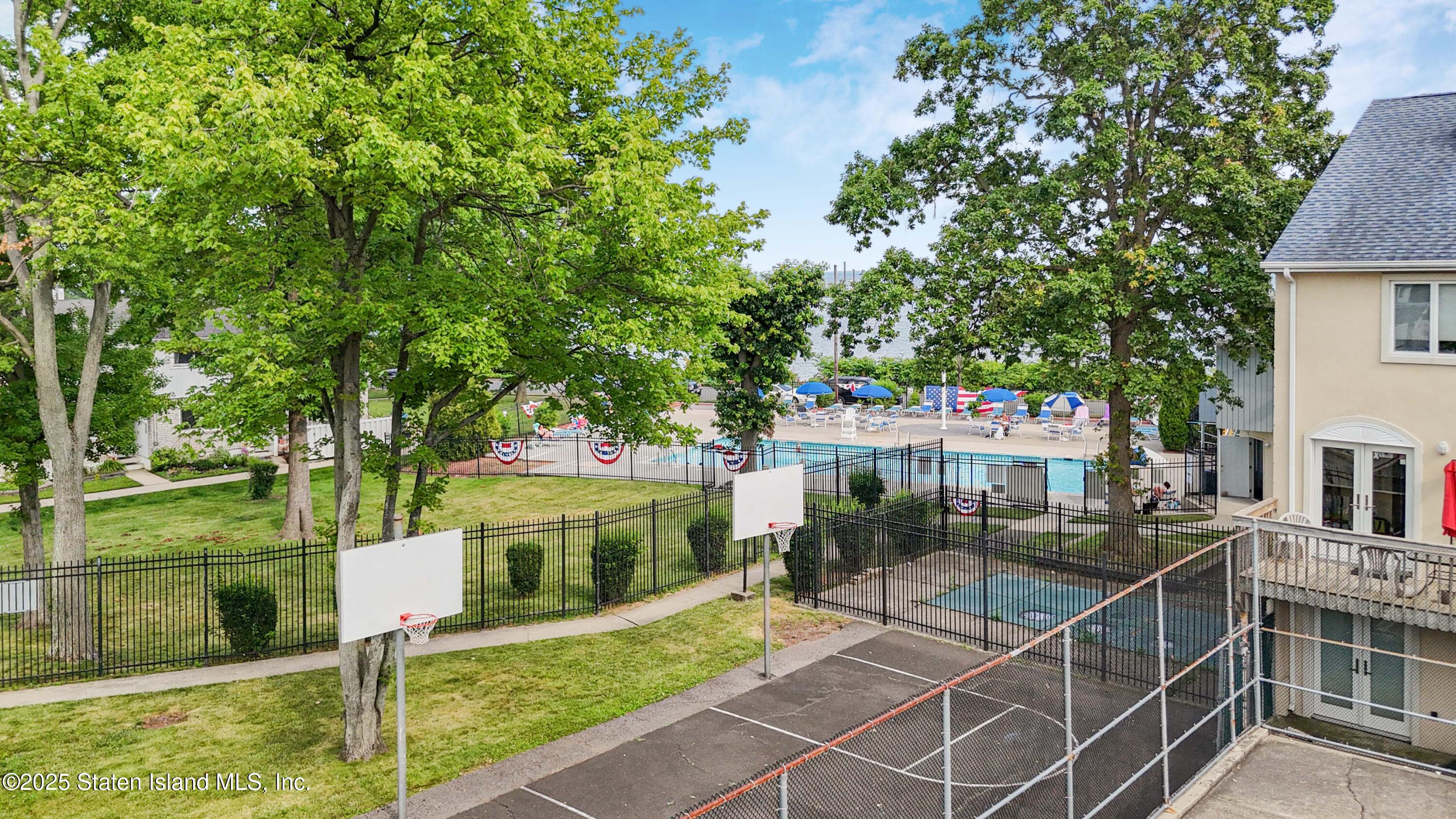 175 Winding Woods Loop, Unit 69 Staten Island, NY 10307 - Photo 27 of 29 a view of a patio with table and chairs and potted plants