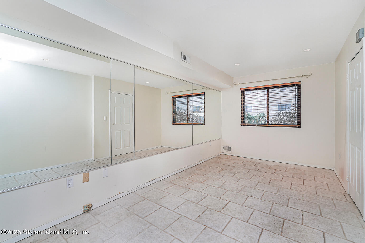 175 Winding Woods Loop, Unit 69 Staten Island, NY 10307 - Photo 4 of 29 a view of an empty room with a window