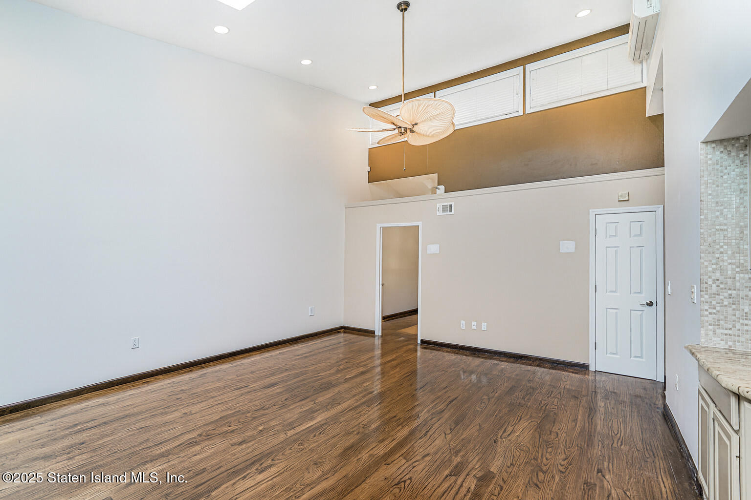 175 Winding Woods Loop, Unit 69 Staten Island, NY 10307 - Photo 9 of 29 a view of a big room with wooden floor and windows