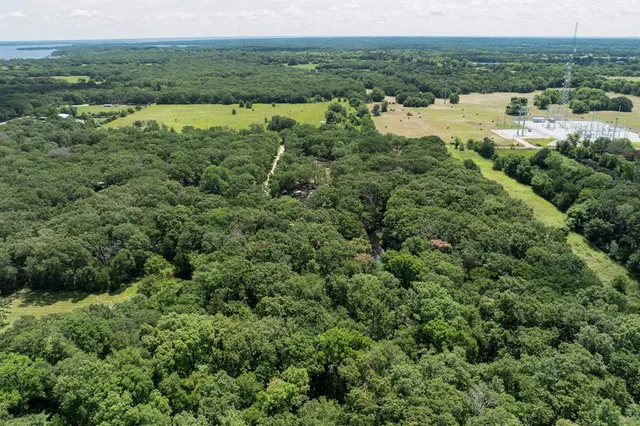 an aerial view of field with beach
