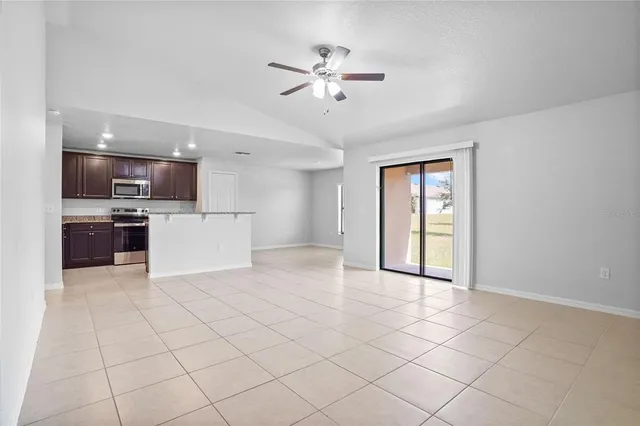 a view of a livingroom with furniture cabinets and stainless steel appliances