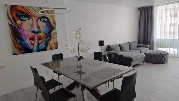 a view of a dining room with furniture and window