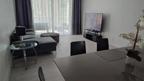 a bedroom with furniture and a flat screen tv