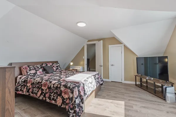 a bedroom with double bed and a flat screen tv