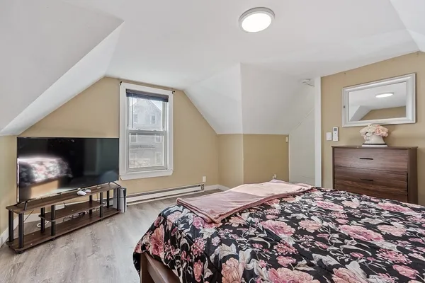 a bedroom with a bed and a flat screen tv