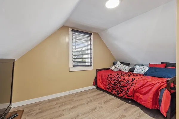 a bedroom with a bed and a window