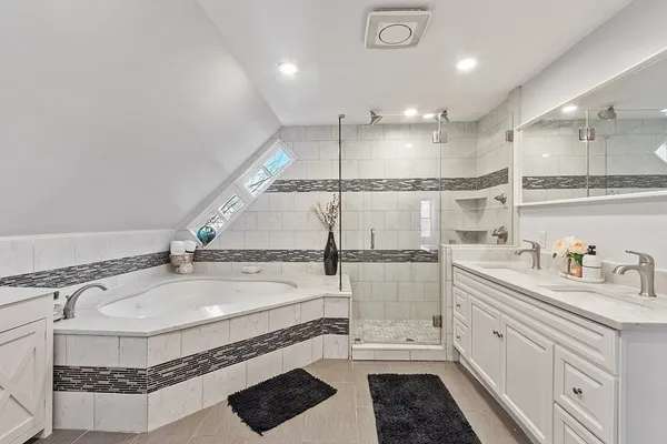 a bathroom with a sink a toilet and a shower