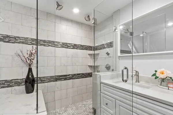 a bathroom with a double vanity sink and a shower