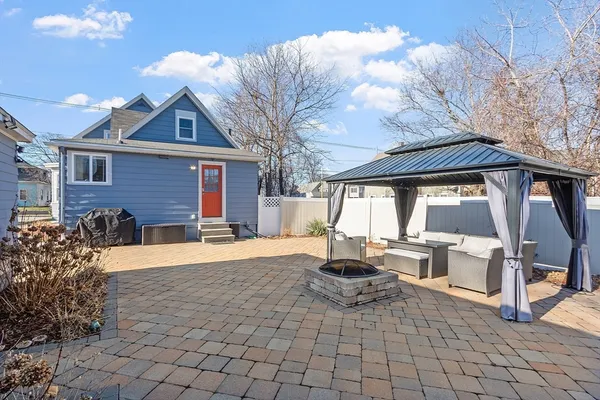 a front view of house with yard outdoor seating and barbeque oven