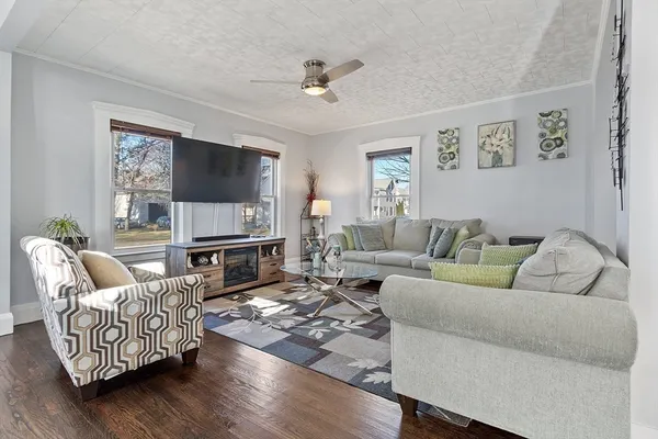 a living room with furniture fireplace and a flat screen tv