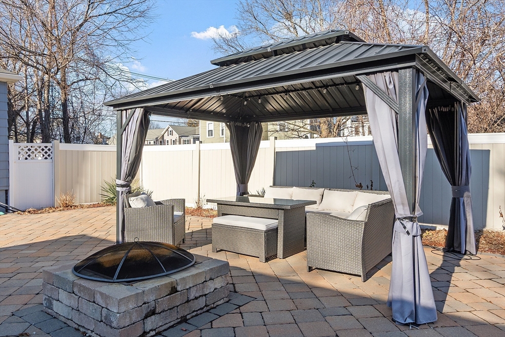 459 High Street Clinton, MA 01510 - Photo 31 of 35 a roof deck with table and chairs a barbeque