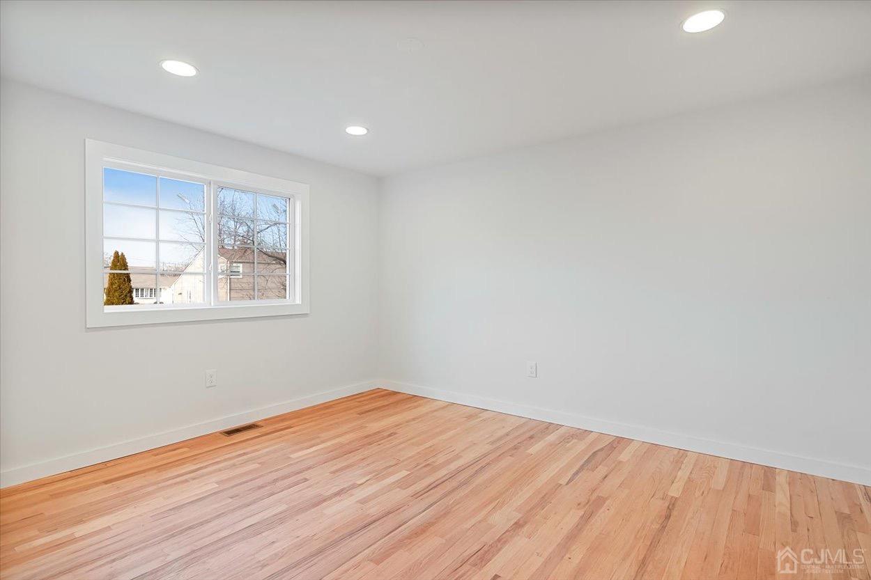 47 Eardley Road Edison, NJ 08817 - Photo 21 of 29 a view of empty room with wooden floor and fan