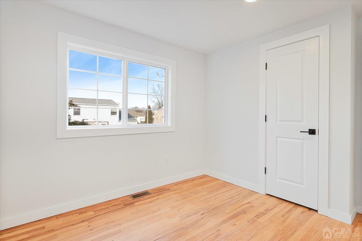 47 Eardley Road Edison, NJ 08817 - Photo 22 of 29 a view of empty room with wooden floor and fan