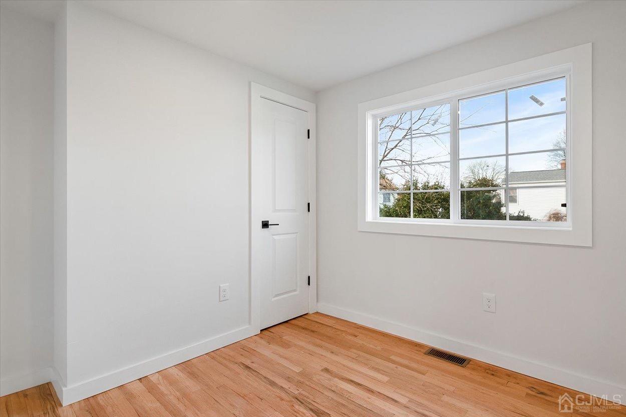 47 Eardley Road Edison, NJ 08817 - Photo 23 of 29 a view of empty room with wooden floor and fan