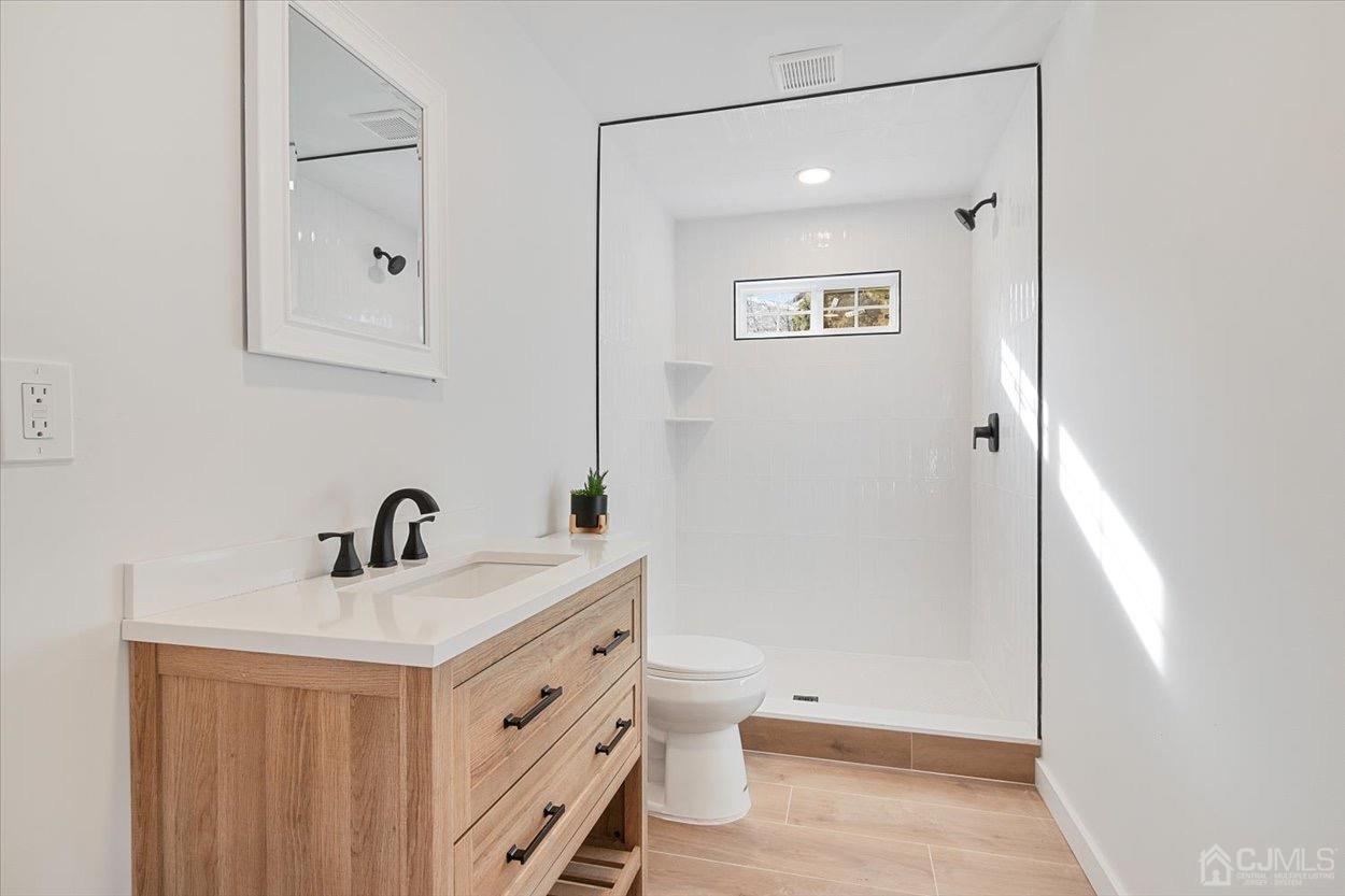 47 Eardley Road Edison, NJ 08817 - Photo 7 of 29 a bathroom with a sink a toilet and shower