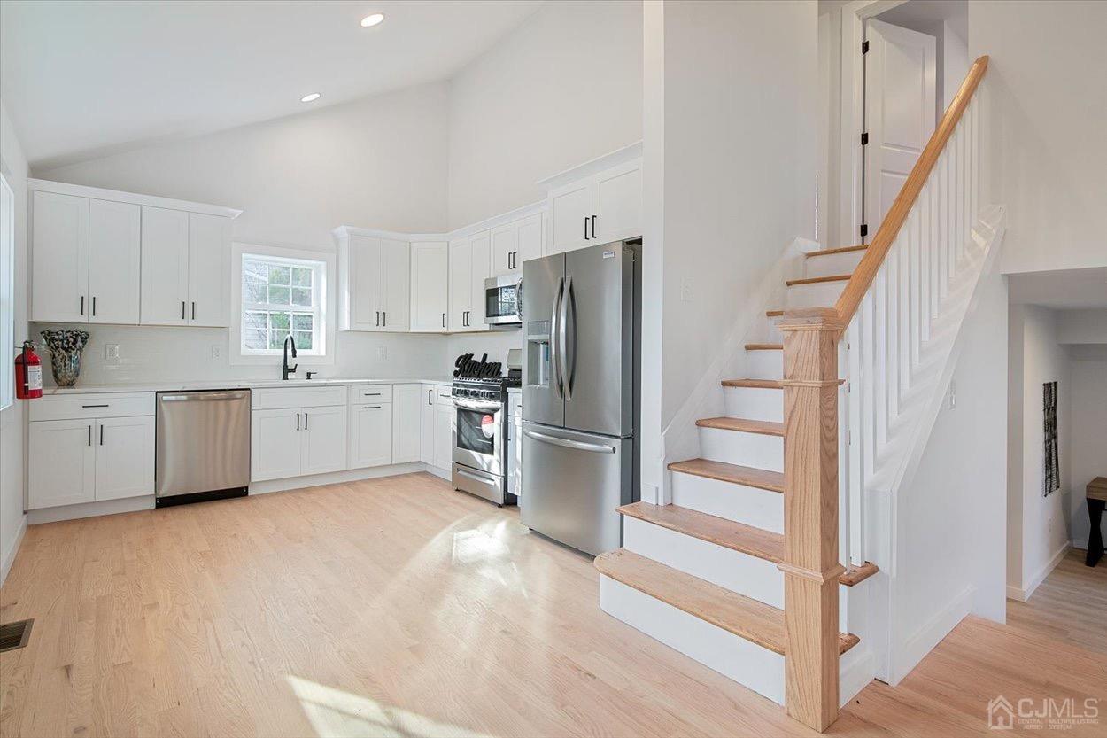 47 Eardley Road Edison, NJ 08817 - Photo 9 of 29 a kitchen with white cabinets and stainless steel appliances