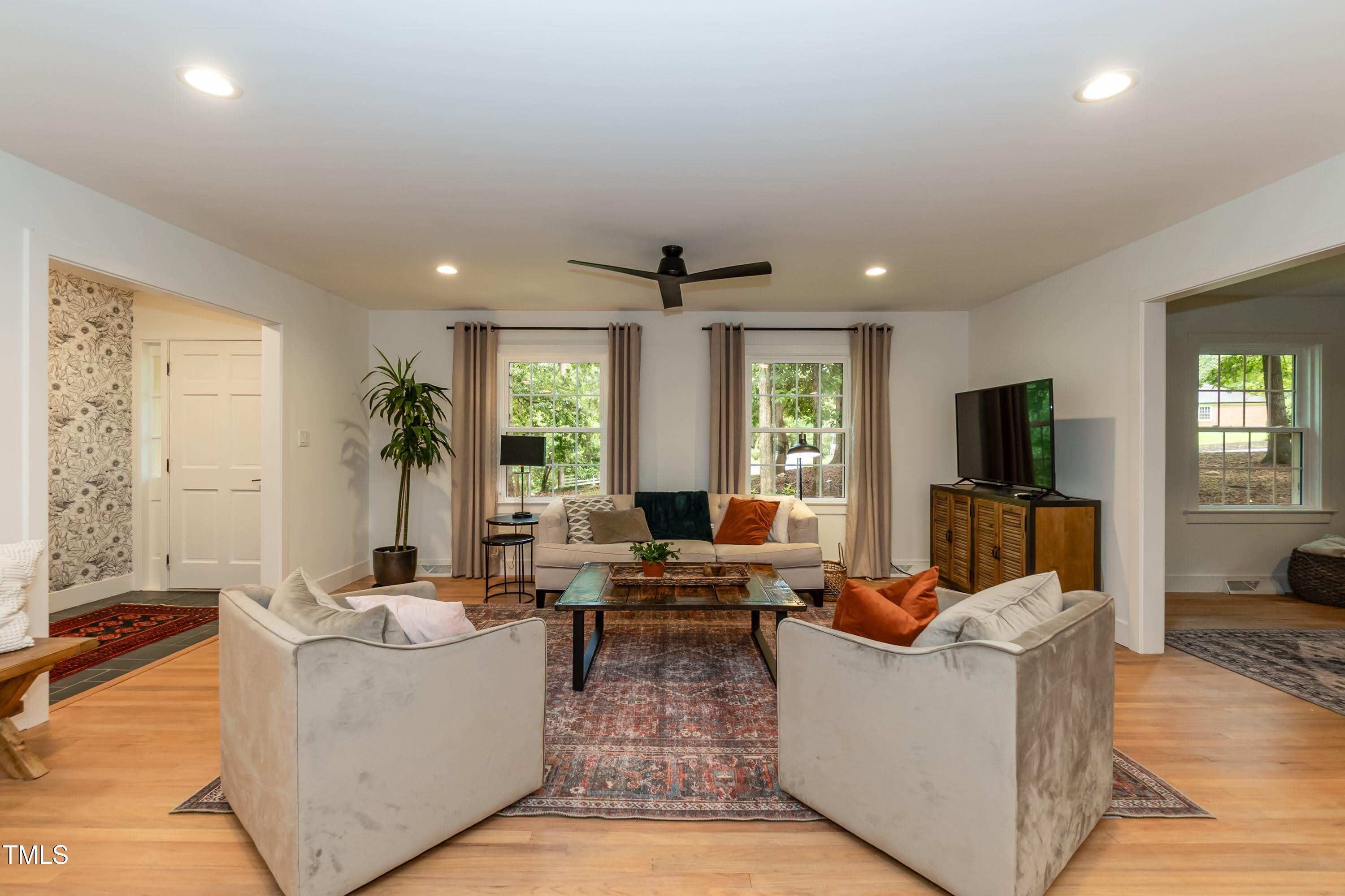 9024 Oneal Road Raleigh, NC 27613 - Photo 5 of 40 The open and airy living room with hardwood floors and recessed can lights.