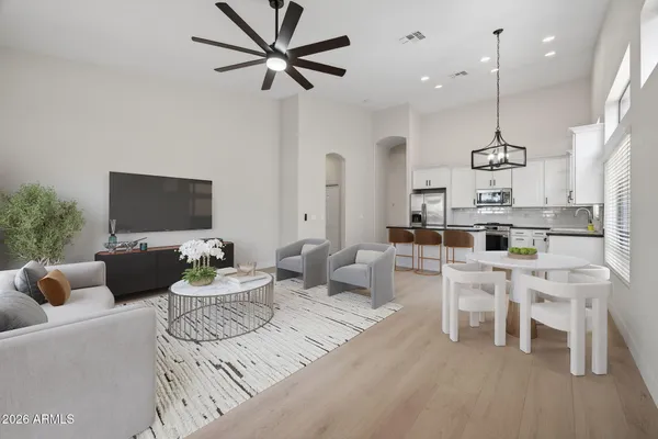 a kitchen with stainless steel appliances granite countertop a refrigerator a stove and a sink with wooden floor