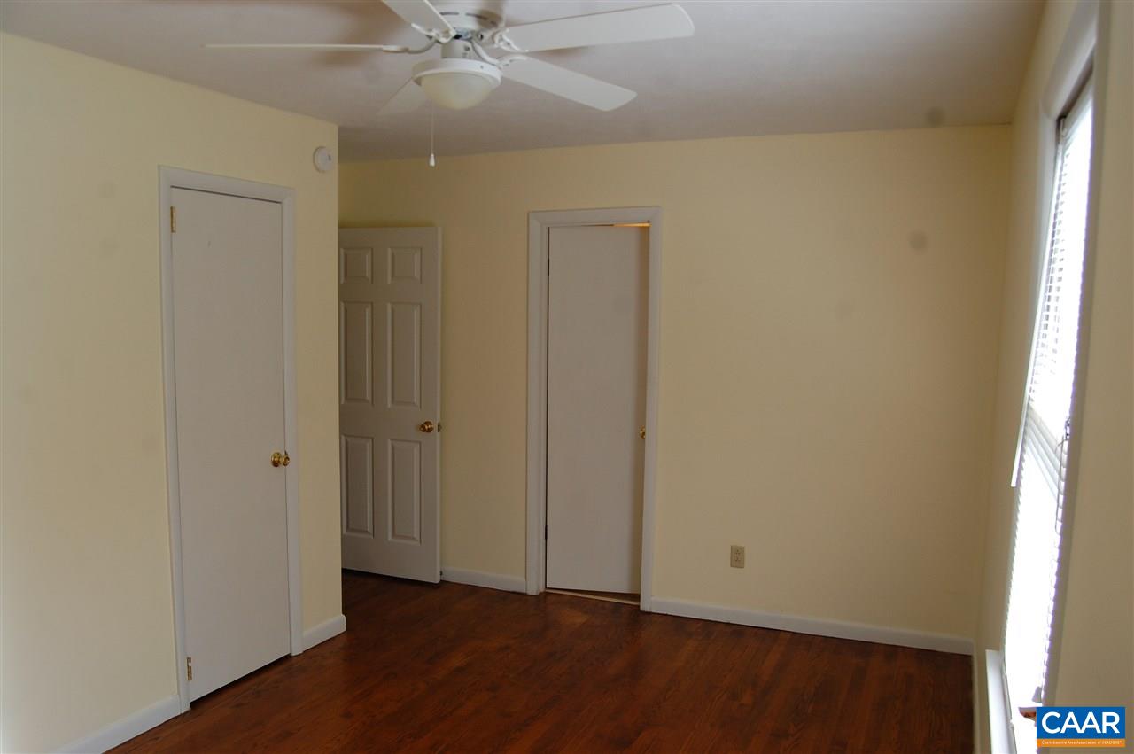 960 Axtell Road Howardsville, VA 24562 - Photo 13 of 18 an empty room with wooden floor closet and windows
