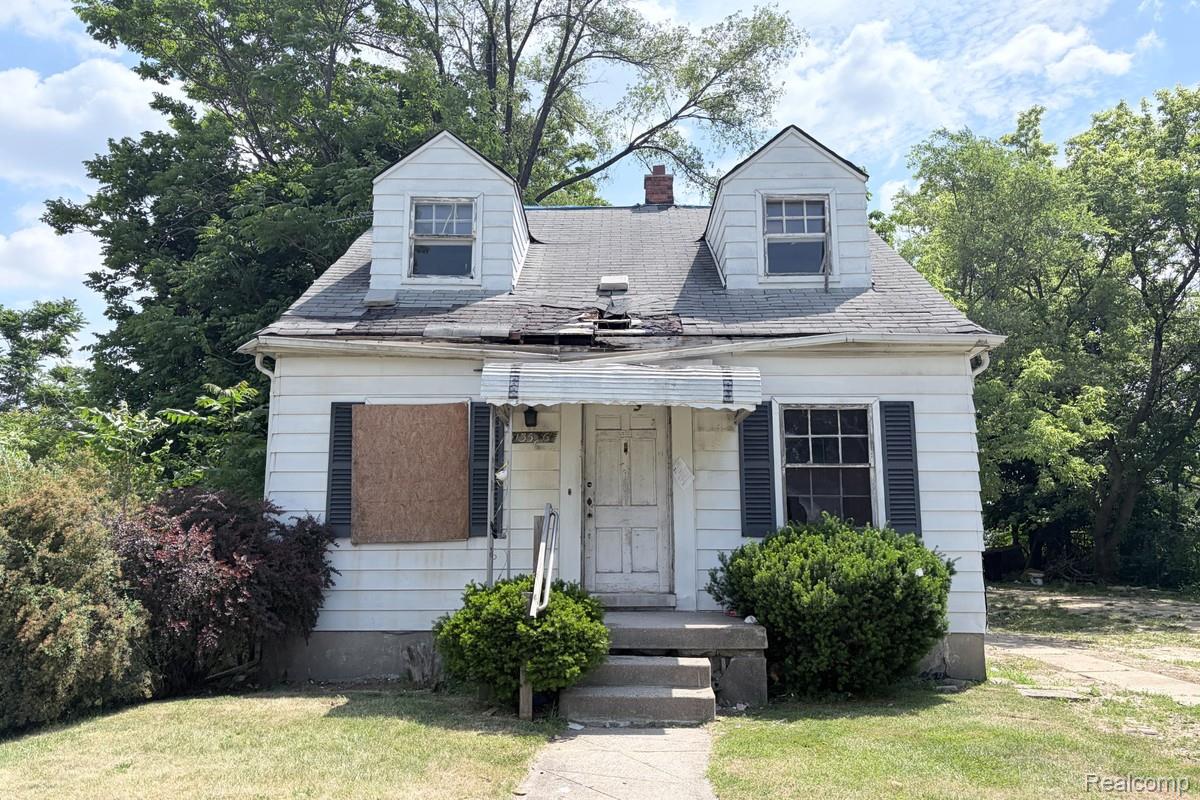 13536 Ashton Road Detroit, MI 48223 - Photo 1 of 9 Exterior featuring white siding, dark window shutters, and a front entry porch with concrete steps
