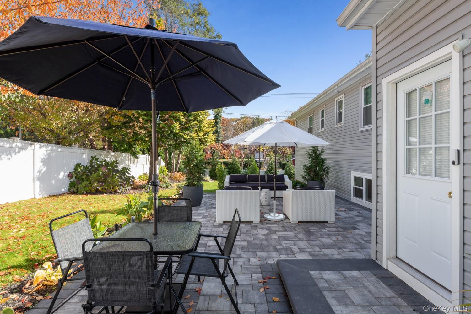4 Long Ridge Road Plainview, NY 11803 - Photo 22 of 27 a view of an outdoor sitting area with furniture and umbrella