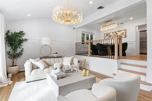 a living room with furniture a chandelier and a chandelier