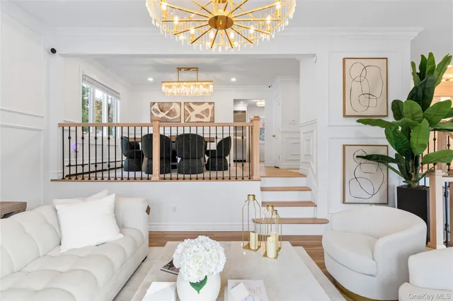 a living room with furniture flowerpot and wooden floor