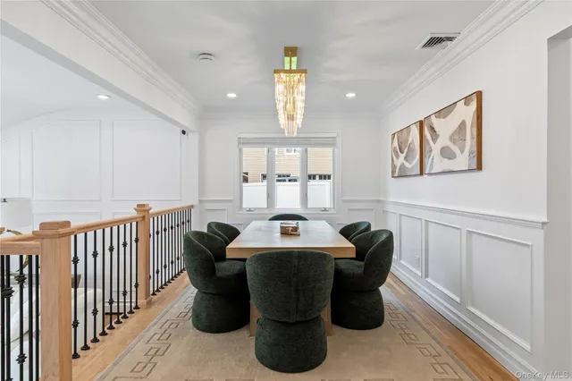 a dining room with furniture a window and wooden floor