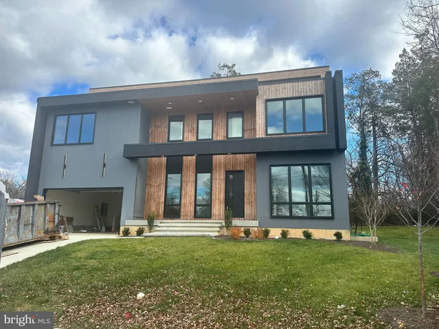 a front view of a residential apartment building with a yard