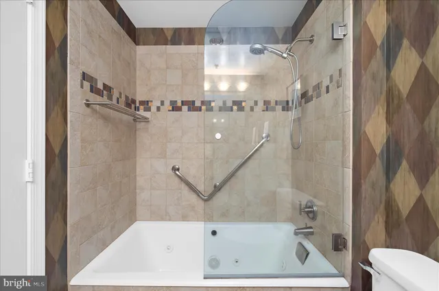 a bathroom with a bathtub and a shower