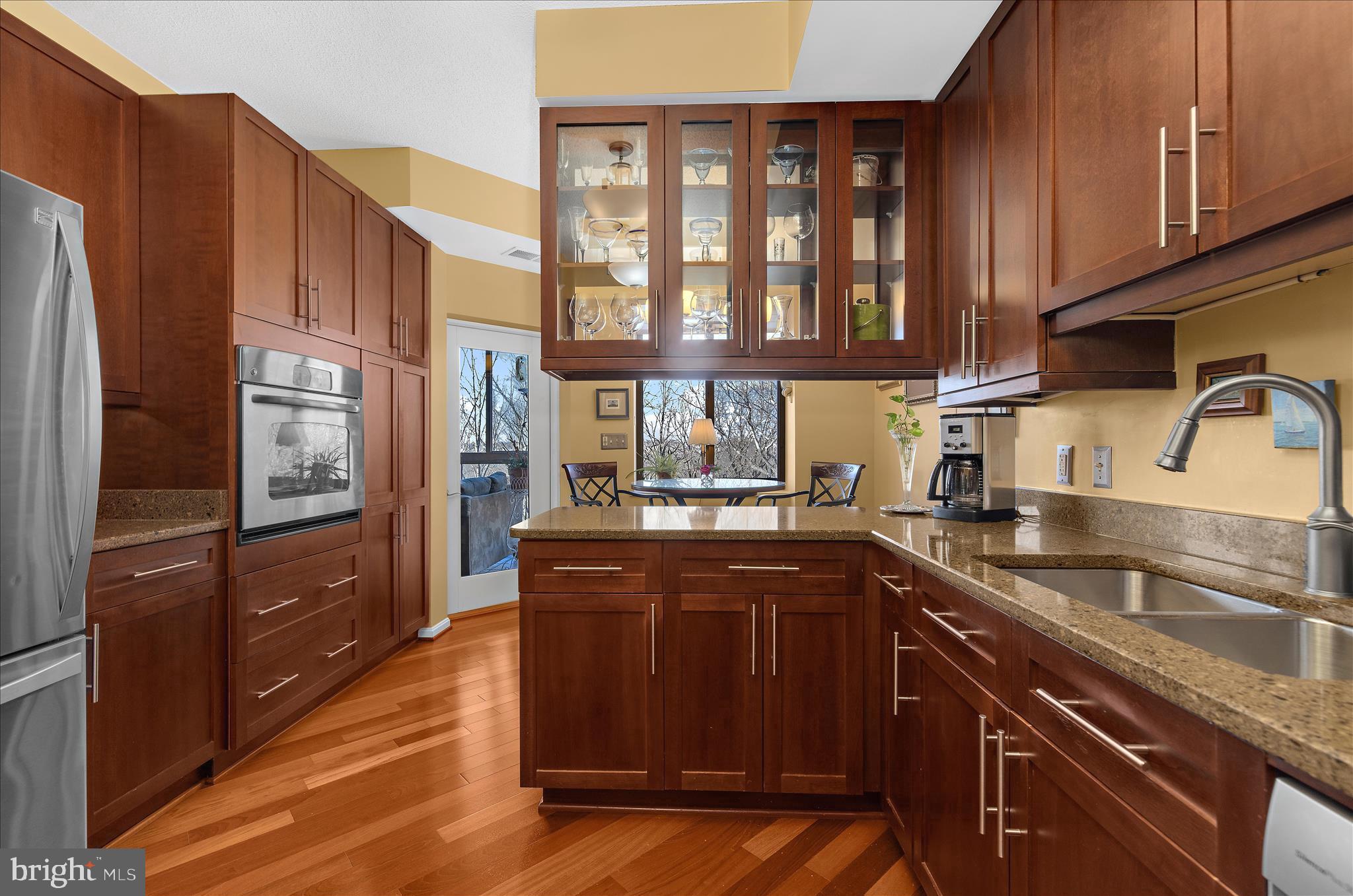 940 Astern Way, Unit 607 Annapolis, MD 21401 - Photo 4 of 45 a kitchen with stainless steel appliances granite countertop a refrigerator a sink dishwasher and wooden cabinets with wooden floor