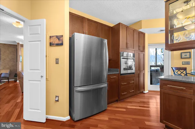 a kitchen with stainless steel appliances granite countertop a refrigerator and a stove