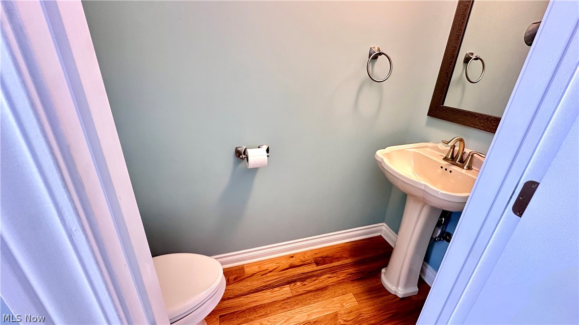 2603 Rockefeller Road Wickliffe, OH 44092 - Photo 24 of 34 Pedestal sink with polished chrome fixtures and a framed mirror