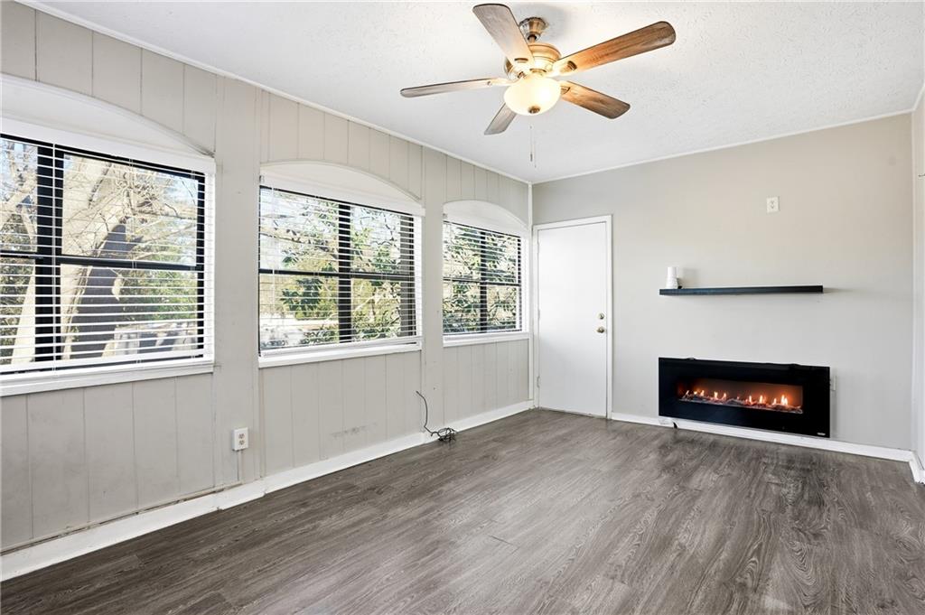 151 Elysian Way Northwest Atlanta, GA 30327 - Photo 11 of 31 a view of an empty room with wooden floor fireplace and a window