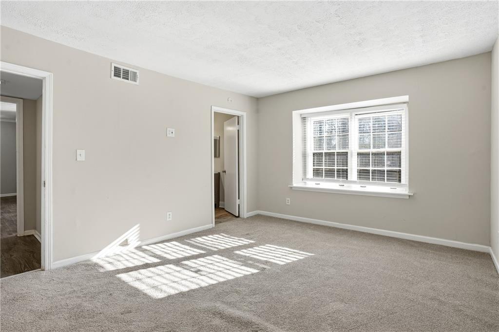 151 Elysian Way Northwest Atlanta, GA 30327 - Photo 17 of 31 a view of a bedroom with window