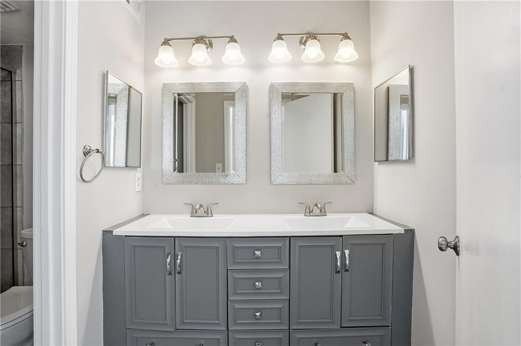 151 Elysian Way Northwest Atlanta, GA 30327 - Photo 19 of 31 a bathroom with a double vanity sink and a mirror