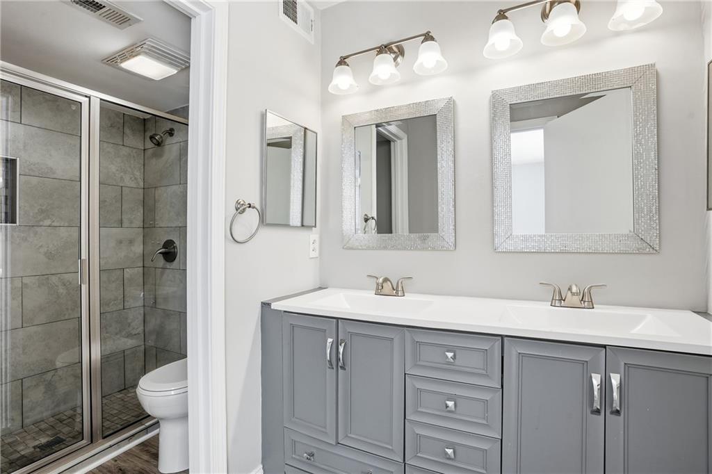 151 Elysian Way Northwest Atlanta, GA 30327 - Photo 21 of 31 a bathroom with a double vanity sink mirror and toilet