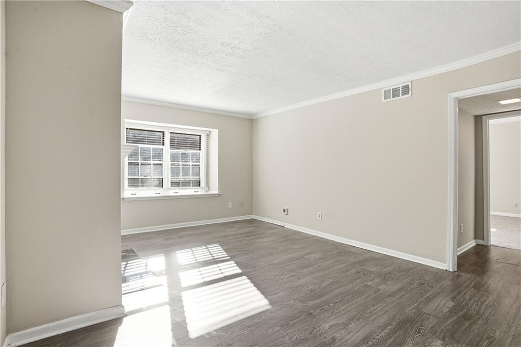 151 Elysian Way Northwest Atlanta, GA 30327 - Photo 4 of 31 an empty room with wooden floor and windows