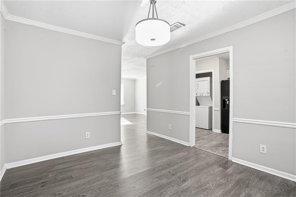 151 Elysian Way Northwest Atlanta, GA 30327 - Photo 6 of 31 an empty room with wooden floor and windows