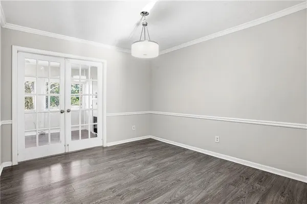 a view of a room with wooden floor and windows