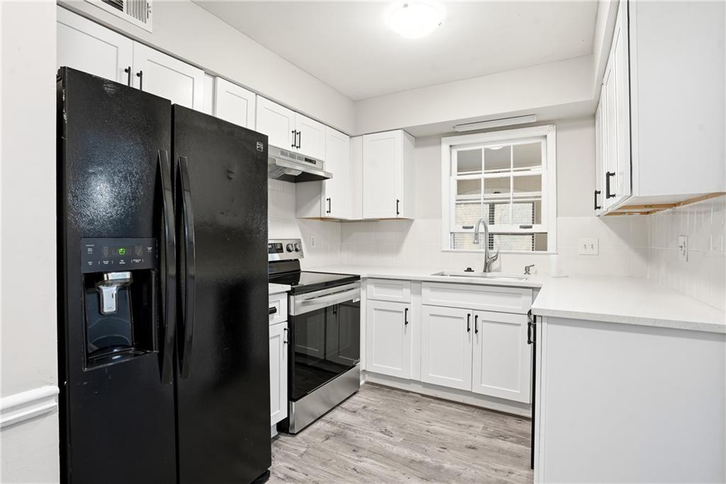 151 Elysian Way Northwest Atlanta, GA 30327 - Photo 8 of 31 a kitchen with a sink stainless steel appliances and refrigerator