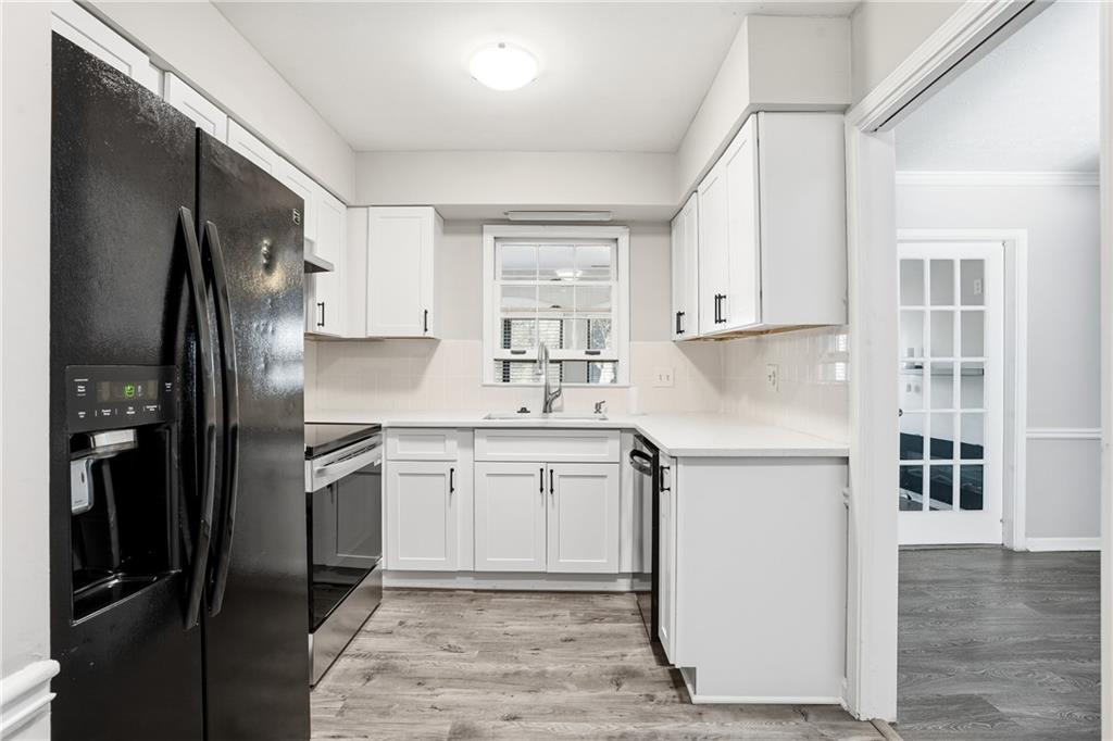 151 Elysian Way Northwest Atlanta, GA 30327 - Photo 9 of 31 a kitchen with a refrigerator sink and cabinets