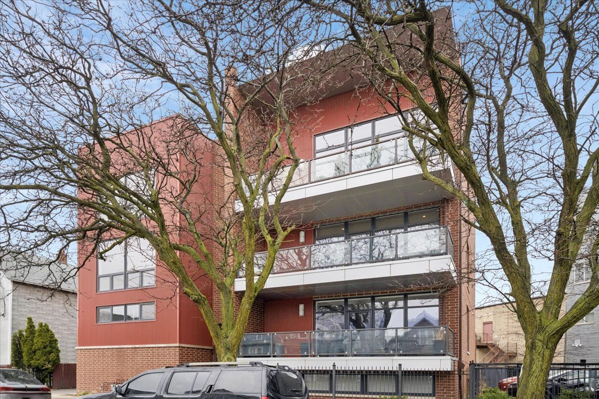 3518 West Wolfram Street, Unit 2 Chicago, IL 60618 - Photo 1 of 34 a front view of a building with trees