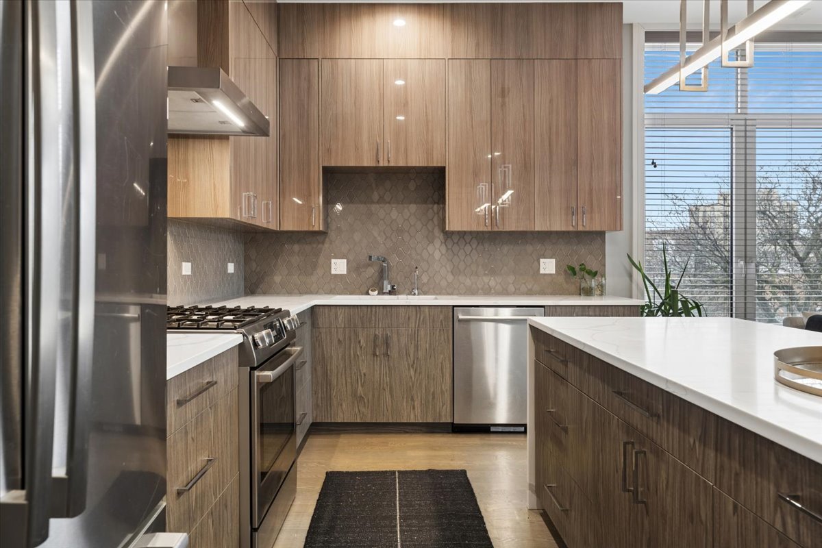 3518 West Wolfram Street, Unit 2 Chicago, IL 60618 - Photo 11 of 34 a kitchen with a sink stove and cabinets