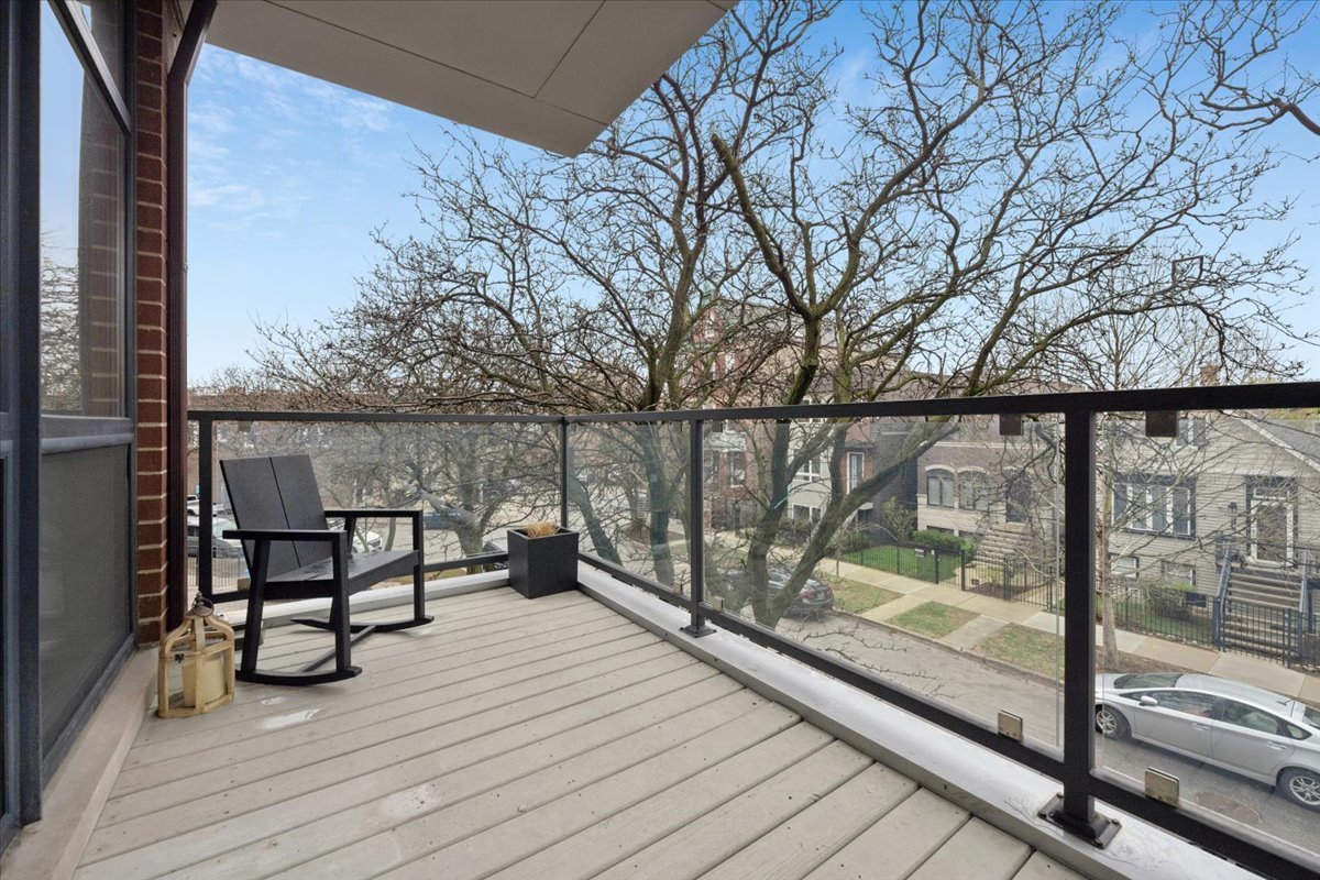 3518 West Wolfram Street, Unit 2 Chicago, IL 60618 - Photo 13 of 34 a view of a balcony with chairs and wooden floor