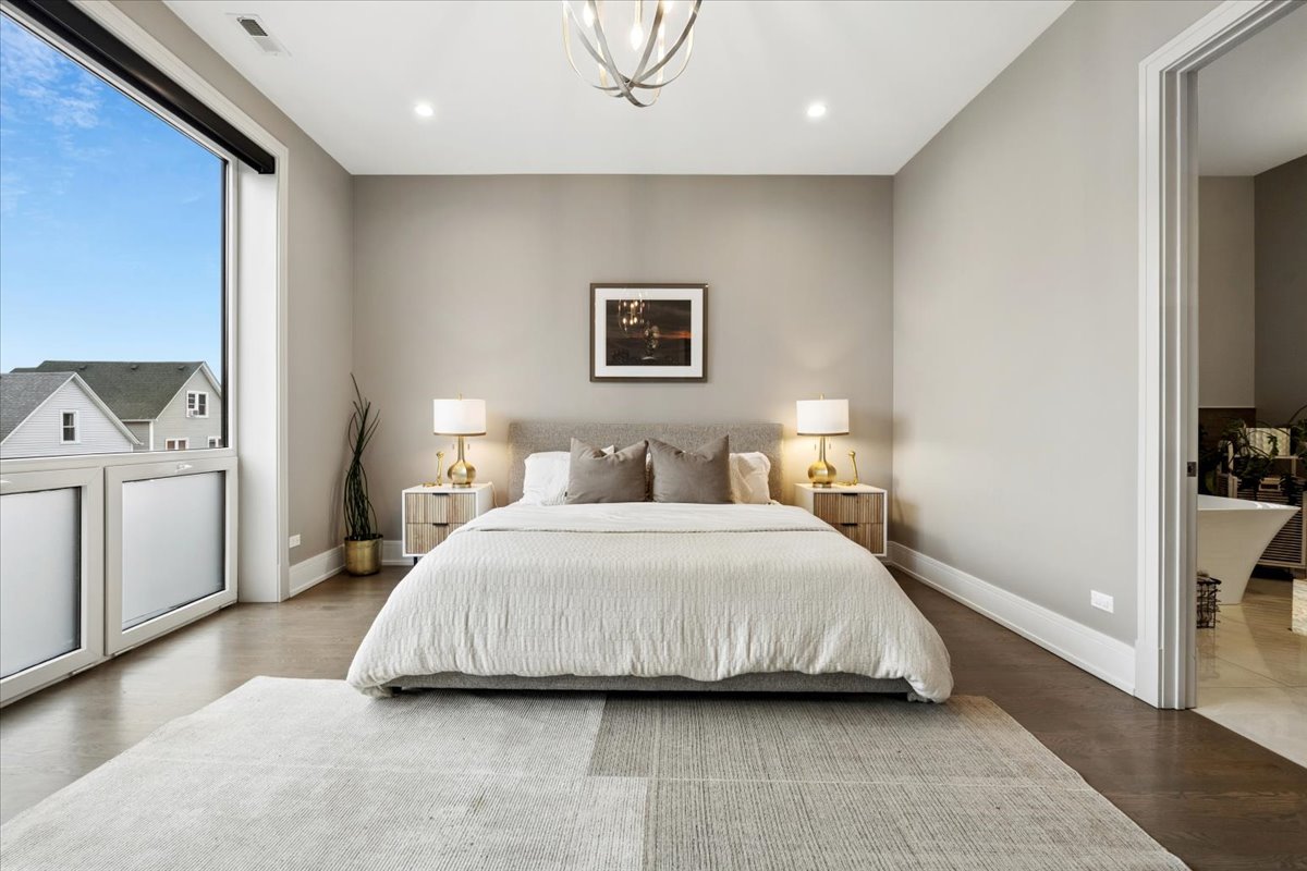 3518 West Wolfram Street, Unit 2 Chicago, IL 60618 - Photo 15 of 34 a spacious bedroom with a bed and a cabinets