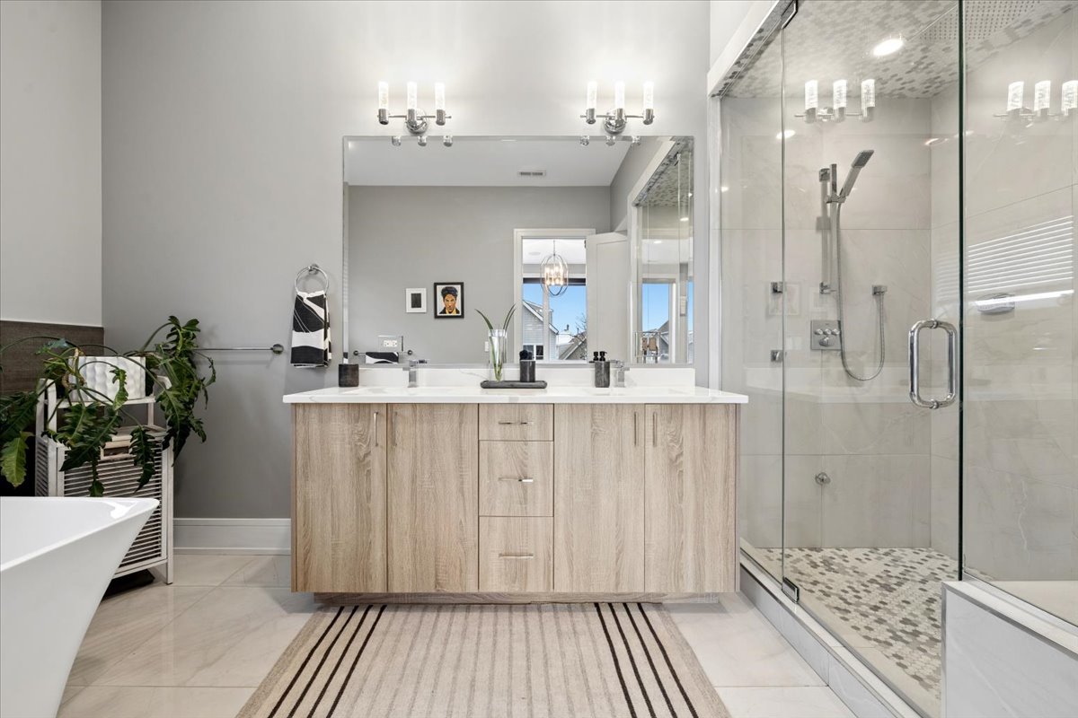 3518 West Wolfram Street, Unit 2 Chicago, IL 60618 - Photo 19 of 34 a bathroom with a double vanity sink and a mirror