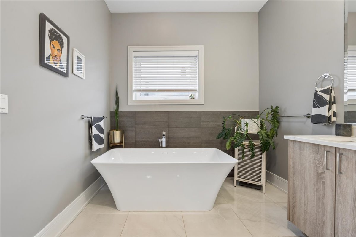 3518 West Wolfram Street, Unit 2 Chicago, IL 60618 - Photo 20 of 34 a white bath tub sitting in a bathroom