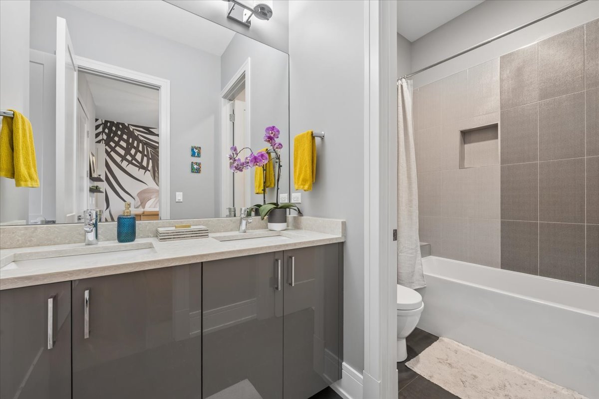3518 West Wolfram Street, Unit 2 Chicago, IL 60618 - Photo 24 of 34 a bathroom with a double vanity sink and a mirror