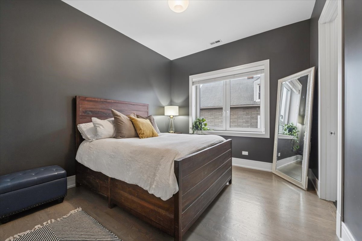3518 West Wolfram Street, Unit 2 Chicago, IL 60618 - Photo 25 of 34 a bedroom with a bed and window